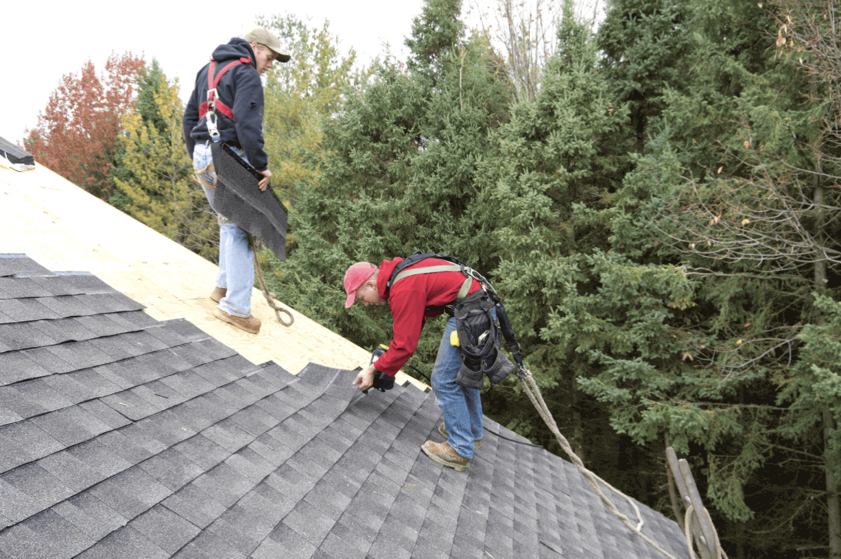 Roofers installing shingles