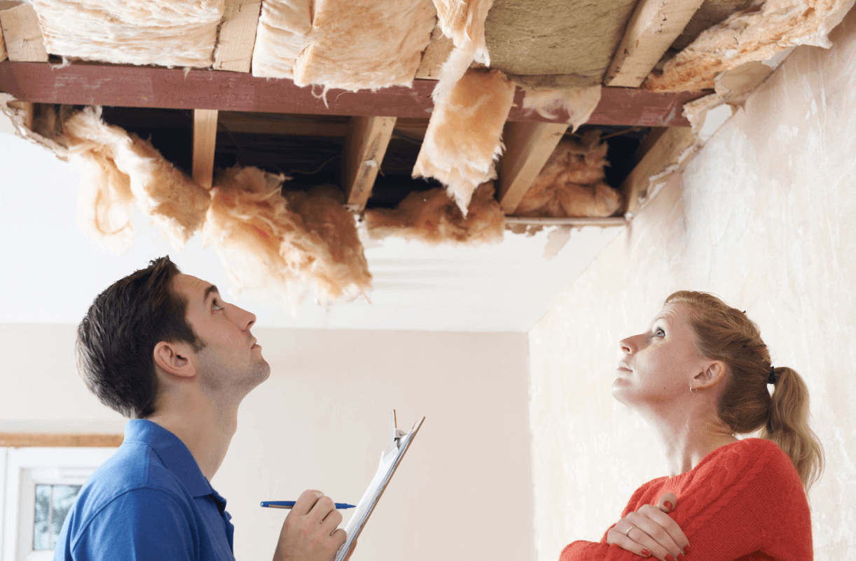Roofing contractor and client investigating the interior damage